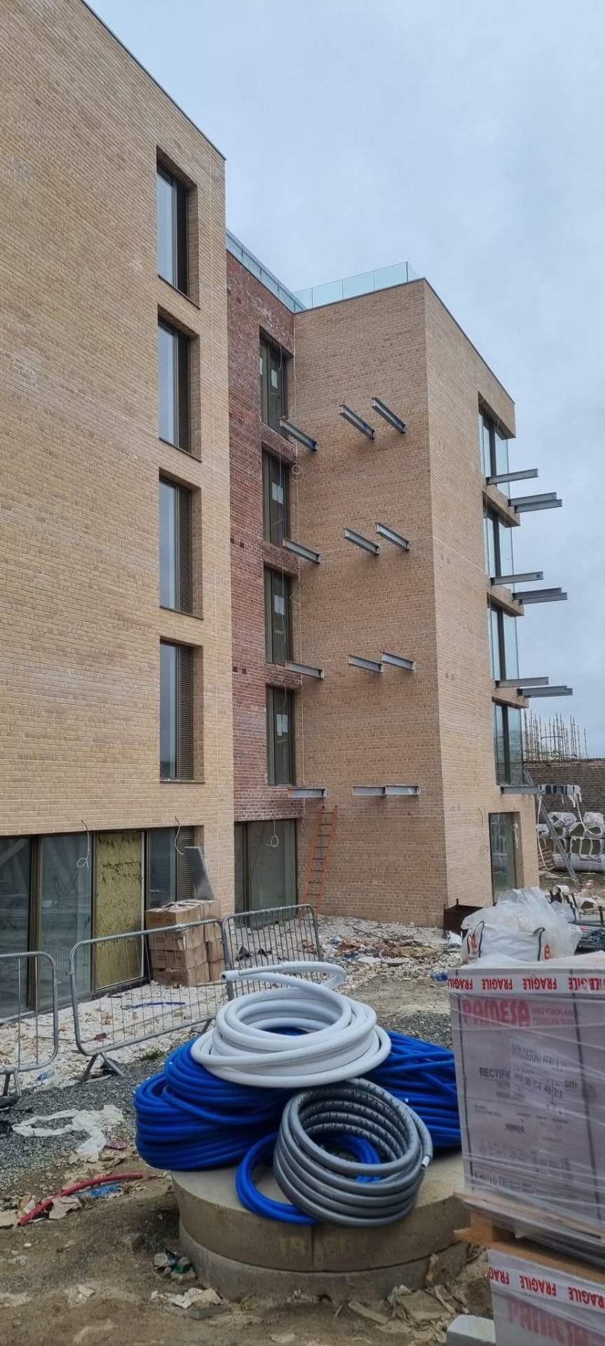 Apartment side elevation mid-build with materials on site