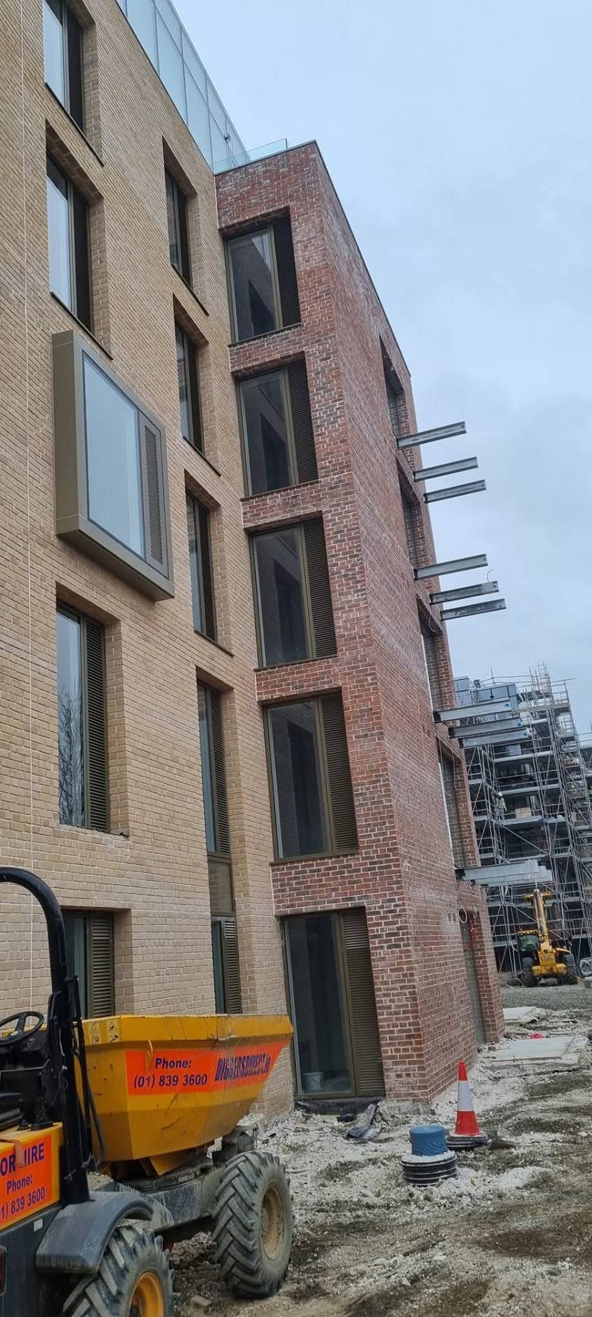 Tall mixed yellow and red brick apartment building