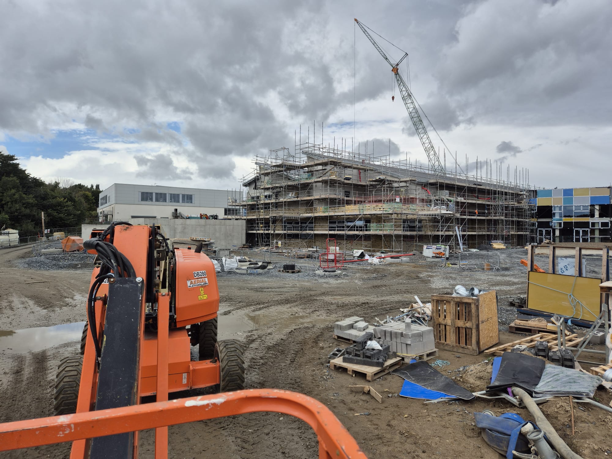 Large school construction site with crawler crane