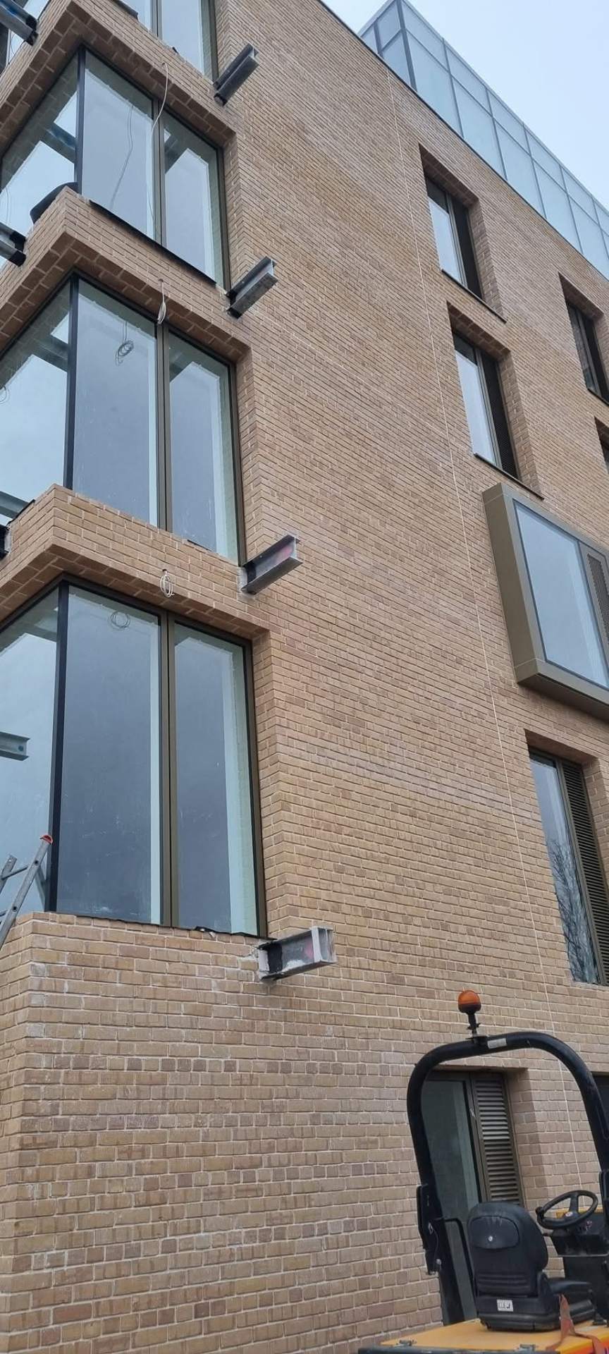 Detailed yellow brick elevation with deep window reveals